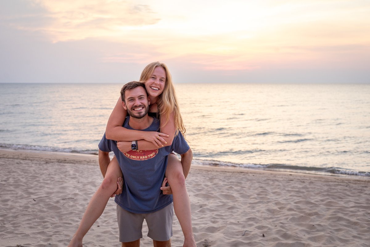 Man giving a woman a piggyback ride on the beach